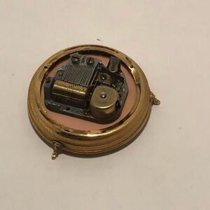 Gold tone part to/ Circular music box